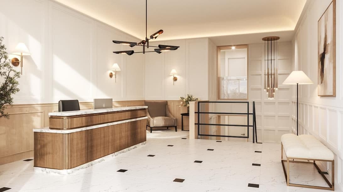 Lobby con piso de mármol en damero, lámparas de bronce y mostrador de madera